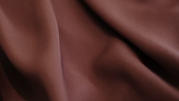 Closeup the motion footage vide. brown Textile abstract background. Clothing industry concept. Wavy material. velours fabric threads macro. Side view. Close-up shooting stock footage — Video Stock