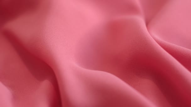 Closeup the motion footage vide. pink textile abstract background. Clothing industry concept. Wavy material. velours fabric threads macro. Side view. Close-up shooting stock footage — Video Stock