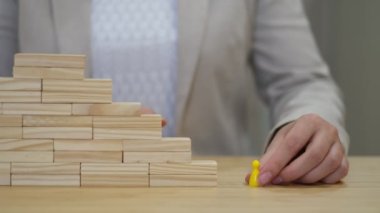 Kadın tüm basamakları atlar ve figürü merdivenin en başına koyar. Kariyer geliştirme konsepti. Başarılı bir işçinin terfisi.