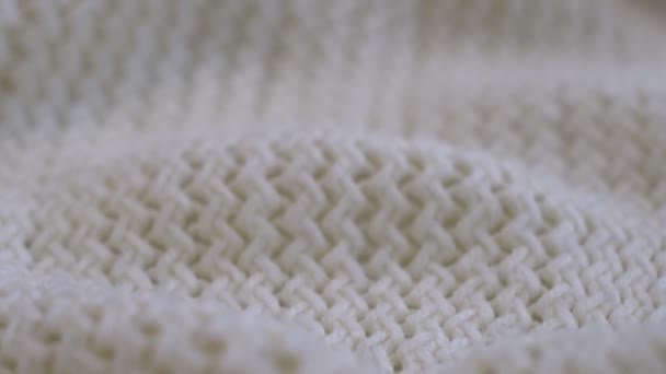 Closeup the motion footage vide. Textile abstract background. Clothing industry concept. Wavy clean material. Fibers of knitted clothes with white threads. Knitted fabric threads macro. — Video Stock