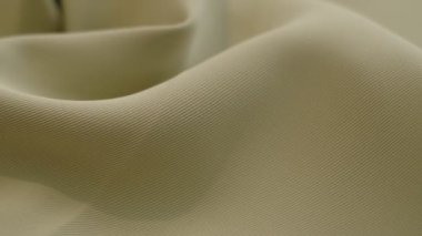 closeup the motion footage vide. green textile abstract background. Clothing industry concept. Wavy material. velours fabric threads macro. Side view. Close-up shooting stock footage