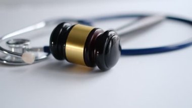 Gavel and stethoscope. medical jurisprudence. legal definition of medical malpractice. attorney. common errors doctors, nurses and hospitals make. Close-up shooting stock footage. slow motion