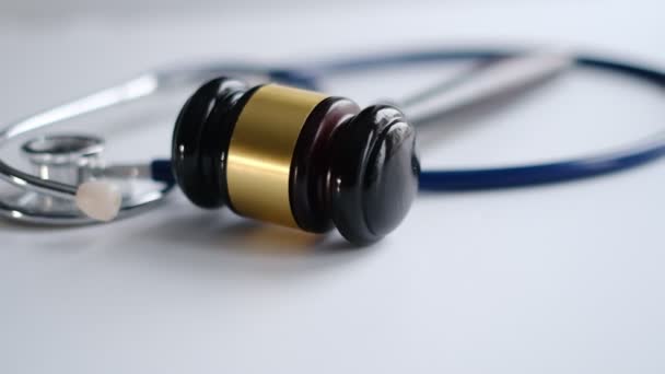 Gavel and stethoscope. medical jurisprudence. legal definition of medical malpractice. attorney. common errors doctors, nurses and hospitals make. Close-up shooting stock footage. slow motion — ストック動画