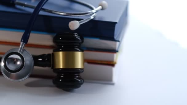 Gavel and stethoscope. medical jurisprudence. legal definition of medical malpractice. attorney. common errors doctors, nurses and hospitals make. Close-up shooting stock footage. slow motion — Stock video