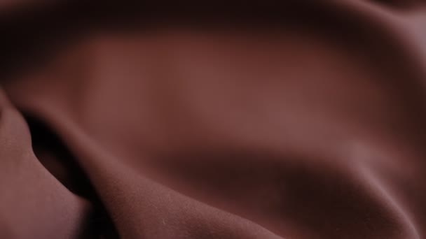 Closeup the motion footage vide. brown Textile abstract background. Clothing industry concept. Wavy material. velours fabric threads macro. Side view. Close-up shooting stock footage — Video Stock