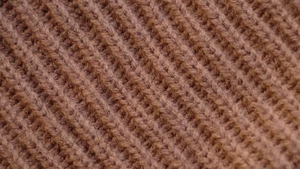 Closeup the motion footage vide. Textile abstract background. Clothing industry concept. Wavy clean material. Fibers of knitted clothes brown white threads. Knitted fabric threads macro. — Video Stock