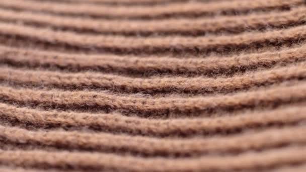 Closeup the motion footage vide. Textile abstract background. Clothing industry concept. Wavy clean material. Fibers of knitted clothes brown white threads. Knitted fabric threads macro. — Video Stock