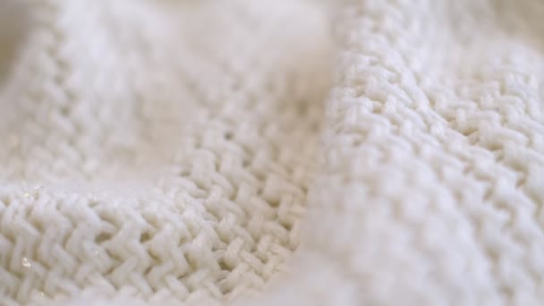 Closeup the motion footage vide. Textile abstract background. Clothing industry concept. Wavy clean material. Fibers of knitted clothes with white threads. Knitted fabric threads macro. — Video Stock