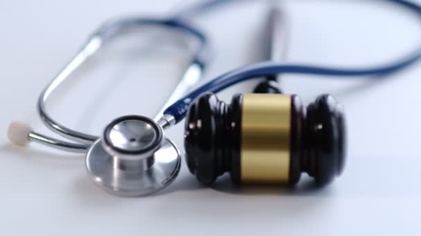 Gavel and stethoscope. medical jurisprudence. legal definition of medical malpractice. attorney. common errors doctors, nurses and hospitals make. Close-up shooting stock footage. slow motion — Wideo stockowe