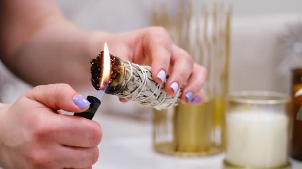 Female hand sets fire to incense on a copper bowl. Aroma therapy, to relax after a hard day. Smells for concentration, purification and clarification of consciousness. — Stock Video