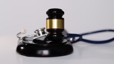 Stetoskop ve muhakeme çekici. Gavel ve steteskop. Tıbbi yargı yetkisi. Tıbbi görevi kötüye kullanmanın yasal tanımı. Avukat. Genel hatalar doktorlar, hemşireler ve hastaneler.