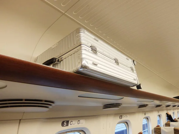 A suitcase on the bullet train luggage rack