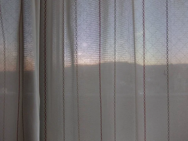 Sunset through lace curtains