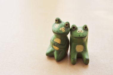 A couple of carved wooden frogs