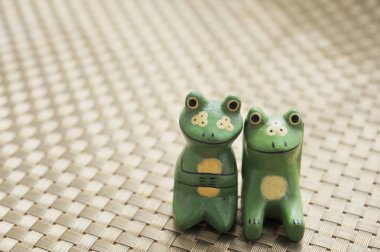 A couple of carved wooden frogs