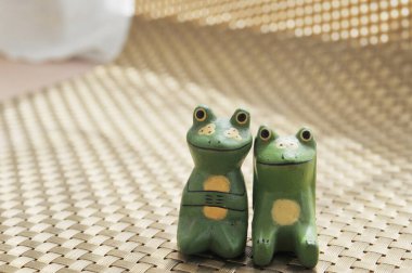 A couple of carved wooden frogs