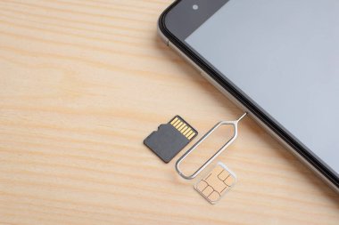 Opening slot for SIM card and micro SD memory card in a modern smartphone using special clip