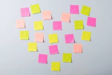 Concept of love, devotion, feeling. Sticky notes in the shape of heart on a whiteboard