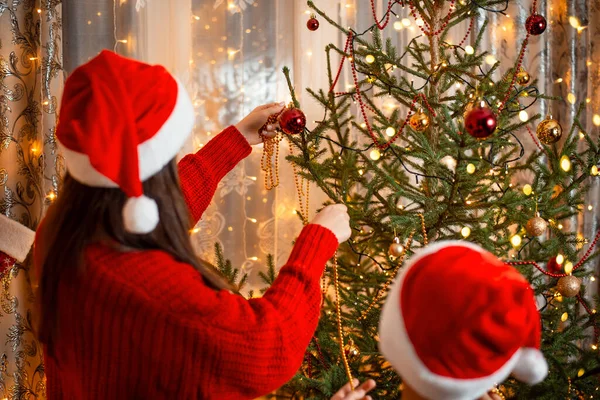 Young Boy Helping Her Elder Sister Decorate Christmas Tree Holding — Foto Stock