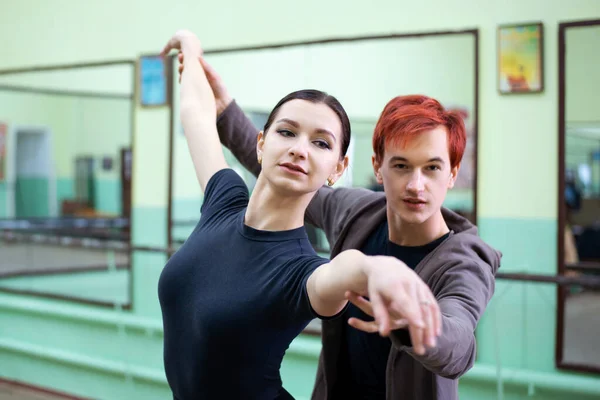 Young male ballet teacher training ballerina to conduct a dance. Improvement of skills to become better and reach perfection.