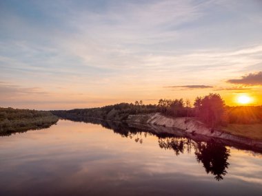 Landscape of calm river flowing in the countryside. Evening at the river