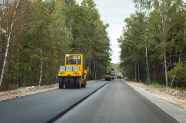 Road roller at a road construction site. Making new high-quality road pavement