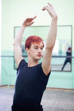 Elegant dancer repeating his performance in the dancing studio. Mastering dancing skills