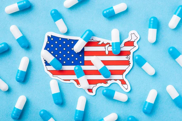 Terrible condition of heath among US citizens. Symbolic photo of many capsules on flag and map of United States