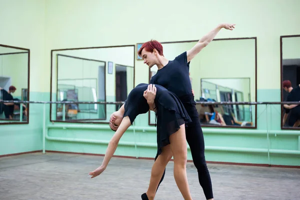 Pair of professional classical dancers performing in the studio. Male and female dancers having training in the dancing hall