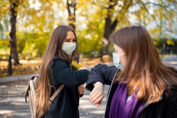 Female Students Friends Protective Medical Masks Greeting One Another Elbows — Stockfoto