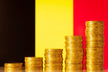 Money stacks in front of flag of Belgium. Financial development of Belgium