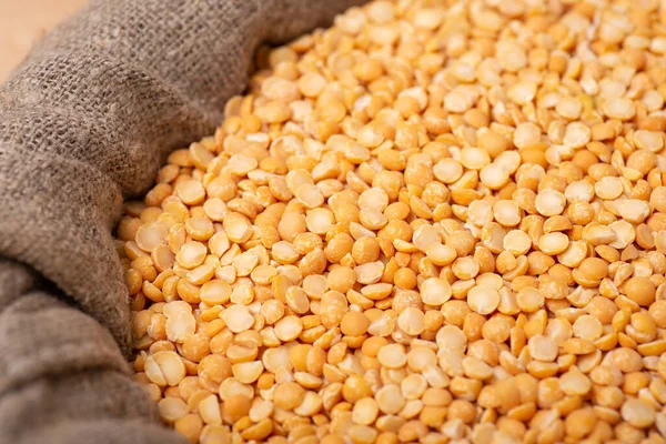 Dried pea in a linen sack. Bright yellow pea ready for cooking