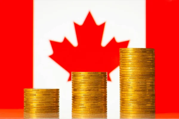 Coins stacks against flag of Canada. Financial development of the country concept