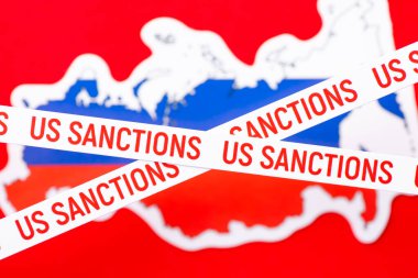 Two lines with inscription Sanctions on the background of Russia map. Concept of sanctions on Russia