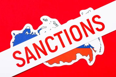 Paper with inscription Sanctions on Russia flag. Sanctions on Russia concept