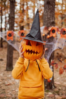 Happy little boy with pumpkin. Halloween celebration concept