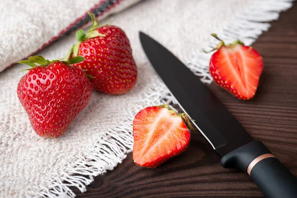 Fresh cut strawberry on white towel. Tasty natural berries