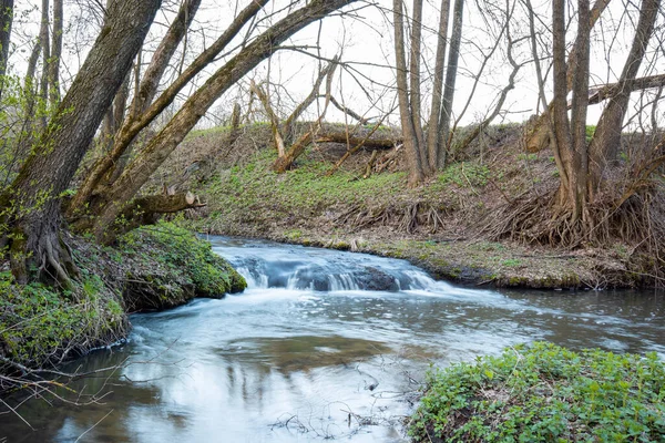 Beautiful small waterfall on the river in spring. landscape of river waterfall in the evening