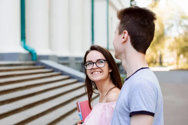 Couple of students walking to classes early in the morning. Happy students in love heading to university together