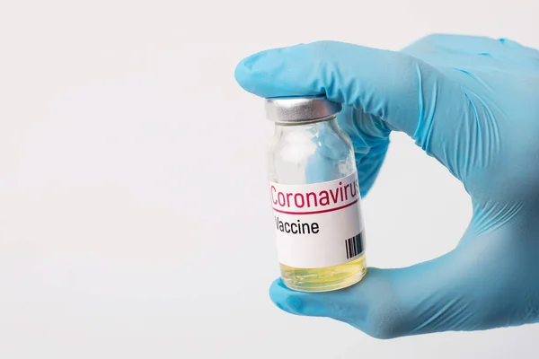 Doctor holds coronavirus vaccine before injection. Concept of inventing vaccine for Covid-19