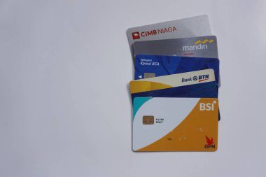 Yogyakarta, kimlik 17 Temmuz 2022. Beyaz arka planda çeşitli Endonezya bankamatik kartları. ATM kartı olarak da bilinir. Cimb Niaga, BSI, Mandiri, BCA, BTN ve BSI. Endonezya 'nın en popüler bankası.