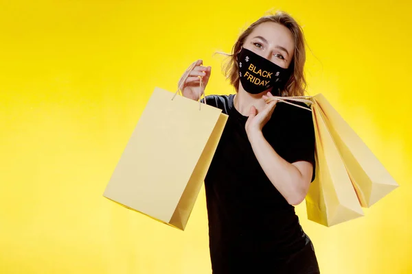 Black Friday Försäljning Kvinna Ansiktsmask Med Black Friday Shoppingväskor Händerna — Stockfoto