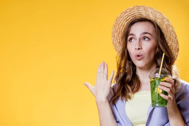 Yaz içeceği. Soğuk içecek. Elinde plastik bardakta alkolsüz içki olan genç bir kadın. Arındırılmış limonata. Tatil gevşemesi.