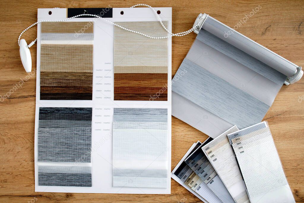 Samples of fabrics of different textures and colors in the form of a catalog for the selection of fabrics for fabric blinds. Samples of blinds day and night
