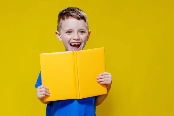 Positive Preschool Boy Bluet Shirt Holding Open Yellow Copybook Yellow —  Fotos de Stock