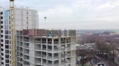 Bir şehirde inşaat halindeki yüksek apartmanın beton çerçevesinin havadan görünüşü