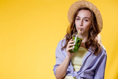 Yaz içeceği. Soğuk içecek. Elinde plastik bardakta alkolsüz içki olan genç bir kadın. Arındırılmış limonata. Tatil gevşemesi