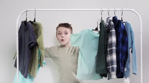 Little Boy Appears Clothes Rack Boy Looks His Shirts Shirts — Stock Video