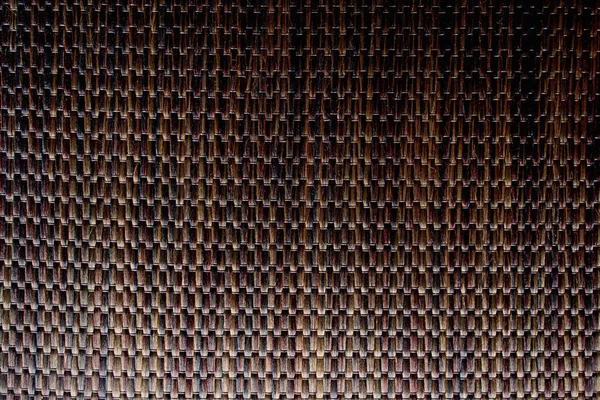 Wicker background made of natural straw. Full frame of densely woven straw pattern. Natural, natural background.