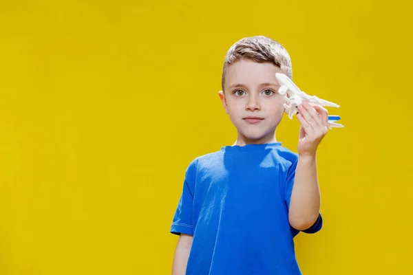 Little Boy Blue Shirt Holds Toy White Plane Plays Yellow — Fotografia de Stock